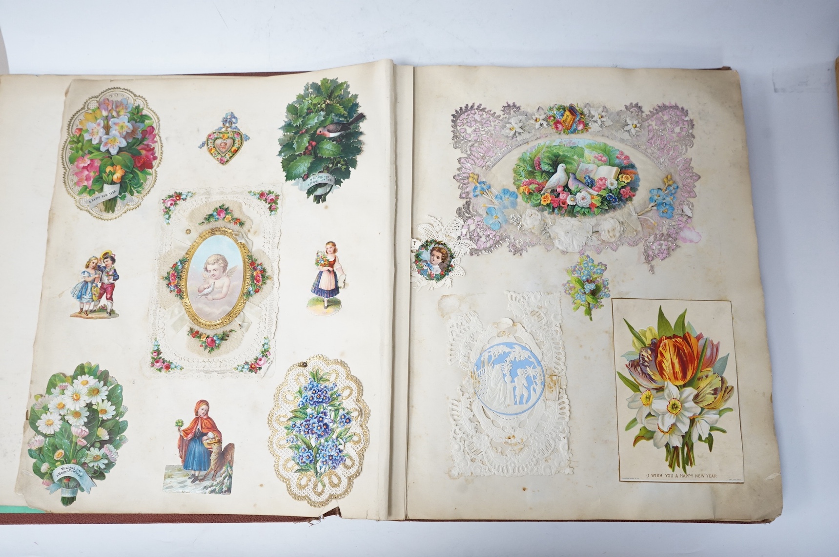 A Victorian album of greetings cards and decoupage. Condition - good